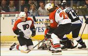 Philadelphia's Kim Johnsson, left, goaltender Robert Esche, center,
and Michal Handzus (26) watch Ruslan Fedotenko's goal for Tampa Bay
in the first period. The Lightning beat the Flyers, 4-2, Tuesday in
Tampa, Fla., taking a 3-2 lead in their best-of-seven NHL playoff
series.
