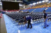 Ramon Rivera, left, and Ramiro Gonzalez put the finishing touches
on the seating arrangements at Allen Fieldhouse for Friday's
lecture by former President Bill Clinton. The stage, seating,
lighting and sound were set up Wednesday in the fieldhouse for the
inaugural Dole Lecture. For details on attending the lecture, see
page 8A.
