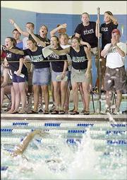 Free State high fans cheer for their team during the final leg of
the 400 freestyle relay. The Firebirds finished second in the event
Saturday at the state meet in Manhattan.
