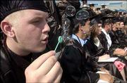Lawrence High School senior Don Carbaugh blows bubbles during the
LHS Class of 2004 commencement ceremony. He received his diploma
May 16 during the ceremony at Kansas University's Memorial Stadium.