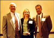rom left, Wint Winter, Michelle Fales and Todd Harris,
representatives of Peoples Bank, accept the Spirit of Caring Award
for a small business. They received the award April 23 at the
SpringHill Suites by Marriott. The award is given by the United Way
of Douglas County and the Lawrence Chamber of Commerce.