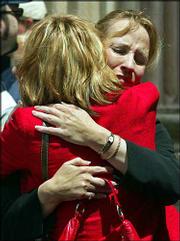 Peggie Pietrowicz, left, hugs her sister, Lynne Gist, during a
lunch break in the penalty phase of the state murder trial of
convicted Oklahoma City bombing conspirator Terry Nichols, in
McAlester, Okla. Pietrowicz and Gist, shown Wednesday, lost their
younger sister, Karen Gist Carr, in the 1995 Oklahoma City bombing.