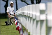 U.S. D-Day veteran Robert Kenney, from Tallassee, Ala., pays his
respects at the American war cemetery at Colleville-sur-Mer in
Normandy, France. The 83-year-old veteran of the 35th Infantry
Division was in Normandy on Saturday for the 60th anniversary
commemoration of D-Day.