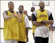 Lakers players Devean George, left, Gary Payton, center, and Karl
Malone joke around after a team practice. The Lakers, shown Friday
in El Segundo, Calif., play Detroit in Game One of the NBA Finals
tonight.