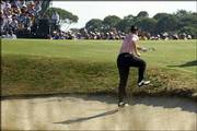 Ernie Els climbs out of a sand trap on the seventh hole to check
his shot. Only one player made a birdie Saturday on the 189-yard
par-3 No. 7 hole, which Els said was 'unplayable.'