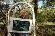 Robert Sudlow displays a painting he created at a pond near his
hillside home south of Lawrence. About 29 Sudlow works in the
private collection of Topekan Horace Eubank will be on view Monday
through July 30 in the Sabatini Gallery at the Topeka and Shawnee
County Public Library.