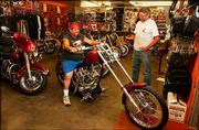 Mike Munoz, Topeka, checks out a Hardcore II 2004 Kit Bike at Hog
Works in Big Springs as the store&squot;s owner, Randy Lester, looks on.
The store is among motorcycle stores across the nation that have
benefited from the reality-television show "American Chopper."