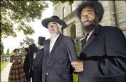 Important figures from the Kansas Territorial period are preparing
for their roles to commemorate the 150th anniversary of the Kansas
Territory in 2004. Gathered Friday at the Douglas County
Courthouse, from left, are David Matheny, who portrays John Brown,
and Charles Everett Pace, who portrays Frederick Douglass.