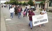 Dozens of people participate in a Unity March down Massachusetts
Street. Saturday's march was part of the Juneteenth celebration,
which recognizes the end of slavery.