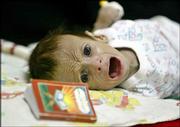 Three-month-old Iraqi boy Ali Mohammed Jabbar cries during
treatment for diarrhea in the General Teaching Hospital for
Children in Baghdad, Iraq, in this June 4 photo. Ali, who prompted
an outpouring of sympathy around the world after he was
photographed in the undersupplied Iraqi hospital, has died, doctors
said Saturday.