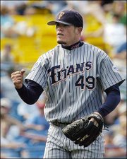 Cal State Fullerton pitcher Jason Windsor celebrates throwing a
shutout. The Titans beat South Carolina, 2-0, Saturday in a College
World Series game in Omaha, Neb. Windsor had a career-high 14
strikeouts.