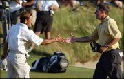 Phil Mickelson, right, shakes hands with playing partner Shigeki
Maruyama after their round at the U.S. Open. Mickelson shot a
2-over-par 72 Saturday in Southampton, N.Y.