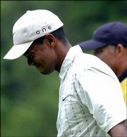 Tiger Woods shows displeasure after a poor tee shot on the sixth
hole. Woods shot a 3-over-par 73 Saturday in Southampton, N.Y., and
is nine strokes back.