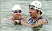 Lawrence High students Katie Barnoskie, left, and her brother,
Marcus, wade in Lake Shawnee before the start of the Topeka Tinman
Triathlon. Katie Barnoskie won the women's short-course race, and
Marcus was eighth in the men's short-course race Saturday in
Topeka.