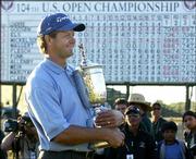 With the leaderboard as backdrop, Retief Goosen poses with the U.S.
Open trophy he won with a final score of 4-under-par 276. Goosen
won the title Sunday at Shinnecock Hills Golf Club in Southampton,
N.Y.