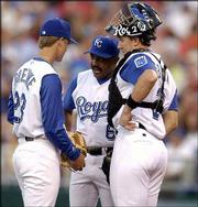 With the bases loaded and facing St. Louis slugger Scott Rolen,
Kansas City starting pitcher Zack Greinke, left, receives a pep
talk from manager Tony Pena, center, and catcher John Buck in the
third inning. Rolen hit a three-run double off Greinke, and the
Cardinals won, 5-2, Friday in Kansas City, Mo.