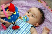 Eliza, diagnosed with a brain tumor on June 8, glances at a toy.
She was released June 18 from Children's Mercy Hospital.