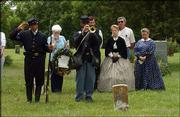 Clinton re-enactors, from left, Jimmy Johnson, of Kansas City, Mo.,
Jonny Johnson (with bugle), Lawrence, Nancy Durbin and Martha
Parker dress in period costumes as they honor those who have been
laid to rest in Clinton Cemetery. The re-enactment was
Saturday.<br>
<a href=
"http://etc.lawrence.com/galleries/chautauqua/3296_lores.html"
target="_new" onclick=
"window.open(&squot;http://etc.lawrence.com/galleries/chautauqua/3296_lores.html&squot;,&squot;Photo&squot;,&squot;height=450,width=450,screenX=10,screenY=10,&squot; + &squot;scrollbars,resizable&squot;); return false;">
<img src="http://www.ljworld.com/art/icons/icon_photo.gif" border=
"0" alt="photo"> Photo gallery: Bloody Kansas
Chautauqua</a><br>
