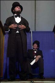 Abraham Lincoln, played by Richard L. Johnson, participates in a
debate with Stephen Douglas, played by Frederick A. Krebs, during
the tent portion of Chautauqua. The Saturday night performance was
at South Park.<br>
<a href=
"http://etc.lawrence.com/galleries/chautauqua/3296_lores.html"
target="_new" onclick=
"window.open(&squot;http://etc.lawrence.com/galleries/chautauqua/3296_lores.html&squot;,&squot;Photo&squot;,&squot;height=450,width=450,screenX=10,screenY=10,&squot; + &squot;scrollbars,resizable&squot;); return false;">
<img src="http://www.ljworld.com/art/icons/icon_photo.gif" border=
"0" alt="photo"> Photo gallery: Bloody Kansas
Chautauqua</a><br>