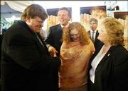 Michael Moore, left, with his wife, Kathleen Glynn, center, and
Lila Lipscomb, right, is greeted by Democratic National Committee
chairman Terry McAuliffe, second from left, as they arrived
Wednesday for the preview of Moore&squot;s film "Fahrenheit 9/11," in
Washington, D.C.