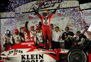 Dan Wheldon, winner of the SunTrust Indy Challenge, celebrates in
victory lane. Wheldon won the race Saturday at Richmond
International Raceway in Richmond, Va.