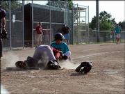 Sidewinders Robb "Yogi" Ferguson slides into River Cats catcher
Chase in a June 23 Houk/Ice league game. The River Cats won the
game 5-4.