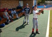 Kyle Branine, 10, Osage City, plays catch with himself between
innings of a game June 29 at the Jayhawk baseball camp at Hoglund
Ballpark.