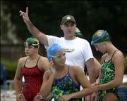 Lawrence Aquahawks coach Mike Soderling, center, works with members
of his team. The Aquahawks' practice session was in full swing at
6:30 in the morning recently at the Lawrence Aquatic Center. That
kind of hard work and dedication has led team members to be so
successful.