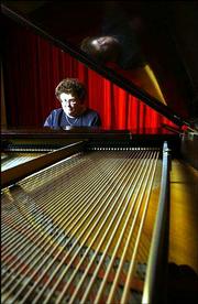 Trilla Lyerla, associate professor of music at Baker University,
practices on a donated grand piano. The university in Baldwin
received $3.88 million in capital and endowed gifts during the past
year. The piano, which Lyerla played on Wednesday, was one of the
items given to Baker.