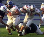 East Quarterback Kaleb Harris (12), who will play for Haskell
Indian Nations University in the fall, heads up field with the help
of a block from Harley Briscoe during the first half. Harris was
named the most outstanding performer following the East's 34-7
victory in the Native American All-Star Football Game on Saturday
night at Haskell Stadium.