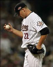 NL starter Roger Clemens looks at the mound during the first
inning. Clemens gave up six runs in the inning Tuesday in Houston.