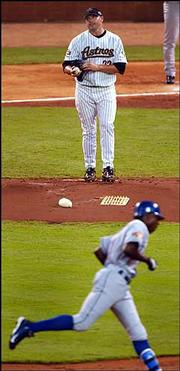 NL starting pitcher Roger Clemens, of the Houston Astros, stands on
the mound as the AL's Alfonso Soriano, of the Texas Rangers, rounds
second base after hitting a three-run home run. The AL squad
roughed up Clemens for six runs in the first inning of the 75th
All-Star showdown en route a 9-4 victory Tuesday night in Houston.
Soriano was named the game's MVP.
