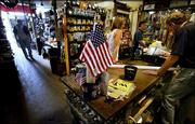 Customers shop at Chagrin Hardware in Chagrin Falls, Ohio, in this
July 3 photo. America's shoppers had a tight grip on their
pocketbooks and wallets in June, dropping sales at retailers by 1.1
percent. It was the largest decline in 16 months.