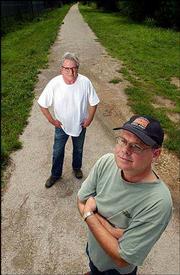 Rails-to-trails advocates Jim McCray, left, and Clark Coan envision
a trail for biking and walking that would span from the Wakarusa
River to the Kansas River. Both are pictured on Monday near 23rd
Street and Learnard Avenue, where the Haskell Trail ends.
