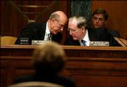 Sen. Pat Roberts, R-Kan., left, and Sen. John Rockefeller, D-W.Va.
discuss a point during a Senate Intelligence Committee hearing. The
panel Tuesday began hearings on a proposal to create a
Cabinet-level post, the director of national intelligence.