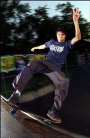 Ian Shelton front-side boardslides the half-pipe at Lawrence's
Centennial Skate Park. The city's skateboard enthusiasts are hoping
major improvements can be made to the 12,306-square-foot facility.