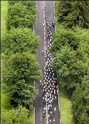 The U.S. Postal Service team leads the pack of riders through the
countryside. The cyclists are pictured riding in the Tour de France
on Friday outside Chevry, France.