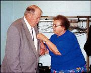 Master Mason Robert Etherton, a member of Lawrence Masonic Lodge
No. 6, receives his 50-year medal from his wife, Jean. The award
was pinned on him during ceremonies June 4 at the Holcom Recreation
Center, 2700 W. 27th St.