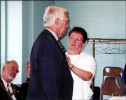 Master Mason Marion Manion, a member of Lawrence Masonic Lodge No.
6, receives his 50-year medal from his wife, Charlene. The award
was pinned on him during ceremonies June 4 at the Holcom Recreation
Center in Lawrence.