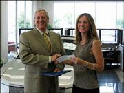 Dale Willey, chairman of Dale Willey Automotive, presents a $1,500
check to Susan Hazlett, executive director of the Lawrence Schools
Foundation, for the Lawrence public schools' automotive
vocational-technical program. He presented the check June 30 at the
dealership, 2840 Iowa. Willey qualified for ambassador status with
the National Automobile Dealers Charitable Foundation, enabling him
to designate the donation, every three years, to the charity of his
choice. Dale Willey Automotive and Lawrence High School are
Lawrence Education Achievement Partners.