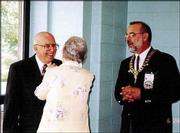 Master Mason Francis Worley, left, a member of Lawrence Masonic
Lodge No. 6, receives his 50-year medal from his wife, Bonnie. The
award was pinned on him during ceremonies June 4. Grand Master
Allan L. Hurlburt, of the Grand Lodge of Ancient Free and Accepted
Masons of Kansas, watches.