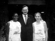 Congressman Dennis Moore, center, visits the Van Go JAMS worksite
during the Benchmark 2004 program. Pictured with Moore are JAMS
apprentice artists LaToya Sweets, left, and Kim Muse. Twenty
apprentice artists are working this summer to create custom benches
commissioned by local businesses and individuals.