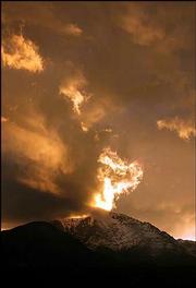 Pikes Peak is shrouded in fiery clouds during a brilliant sunset,
as seen from Colorado Springs, Colo.