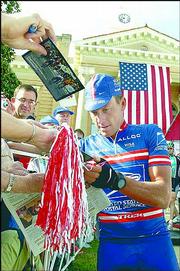 Lance Armstrong signs autographs before the start of the second
stage of the Tour de Georgia in this file photo from April 21 in
Thomaston, Ga. Armstrong won his record sixth straight Tour de
France on Sunday.
