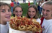 From left, Hannah Elder, 13, Mackenzie Flory, 12, Kelly Baker, 13,
and Tracie Weege, 13, all of Baldwin, enjoy their enormous order of
curly fries at the Douglas County Free Fair Friday. Large portions
are a county fair staple.