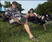 Dick Wise and Melissa Murphy listen to some live music during The
Big Pig, a fund-raiser for the Boys & Girls Club of Lawrence.
The event, which featured all-you-can-eat barbecue, was July 17 at
the Meadowbrook apartment complex in Lawrence.