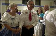 Betty Alexander, left, and Stan Zaremba, right, both of Lawrence
and both members of Tons of Fun Square Dancing Club, promenade
during the club's monthly dance at Dance City, 5150 Clinton
Parkway.