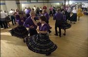Members of the Ottawa square dancing club, foreground, dance during
the monthly dance sponsored by Tons of Fun, the Lawrence square
dancing club. The July 24 dance was at Dance City, 5150 Clinton
Parkway.