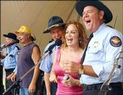 Dukes of Hazzard cast members, from left, Sonny Shroyer as Deputy
Enos Strate, Catherine Bach as Daisy Duke, and Rick Hurst as Deputy
Cletus Hogg, sing to the show's theme song during the 25th
Anniversary DukesFest Saturday, in Bristol, Tenn.