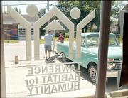 Tony Roe, Perry, left, gets help from Habitat for Humanity
volunteer Dave Baldwin, Lawrence, as they load windows Roe
purchased at the Habitat for Humanity "Prestore Garage Sale."
Proceeds from the sale Friday and Saturday went toward plans to
start a home-improvement thrift store in town.